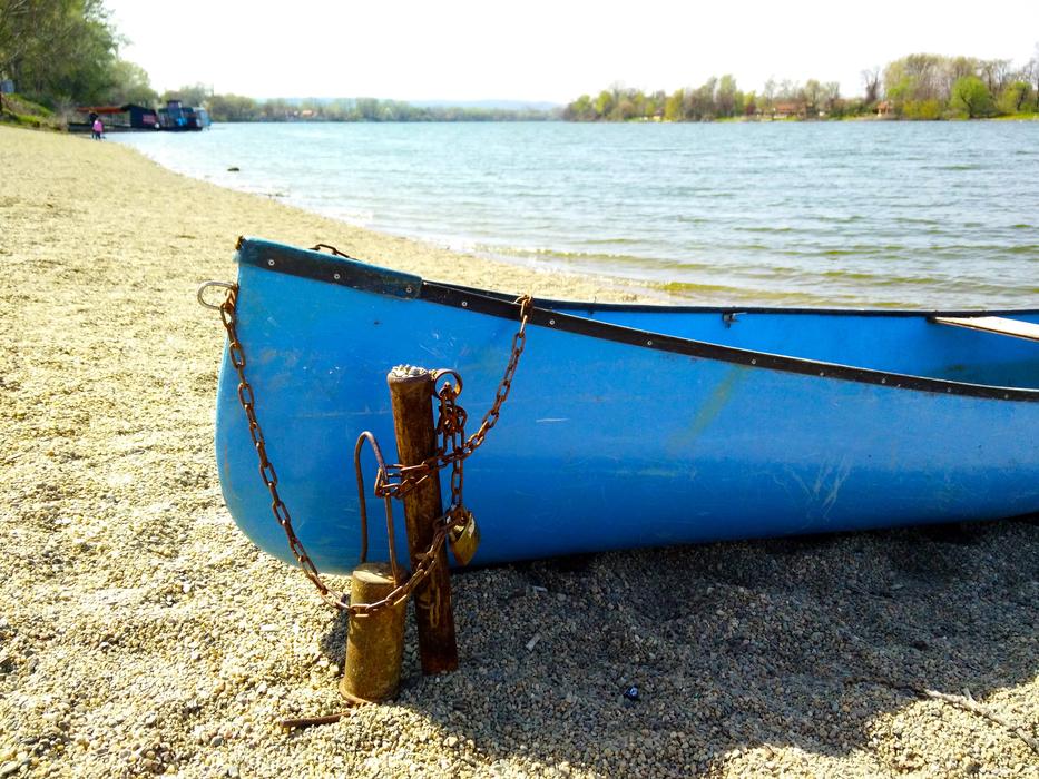 a boat tied up with a rope on the beach