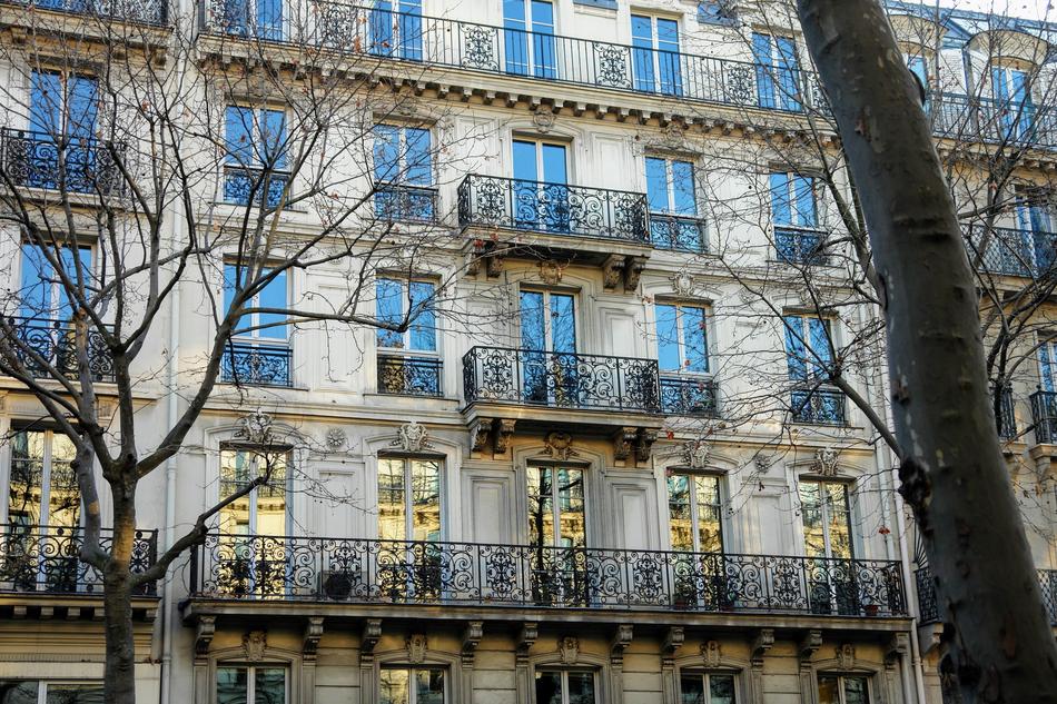 Beautiful building with the decorated, black balconies in Paris, France