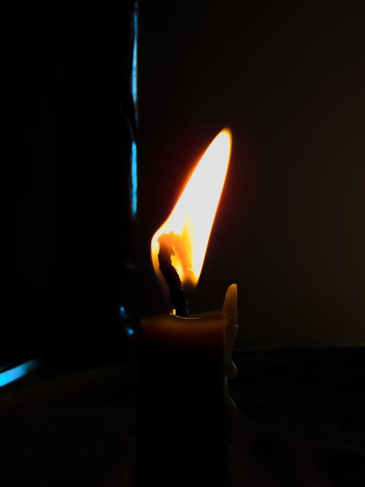 burning Candle with bright Flame