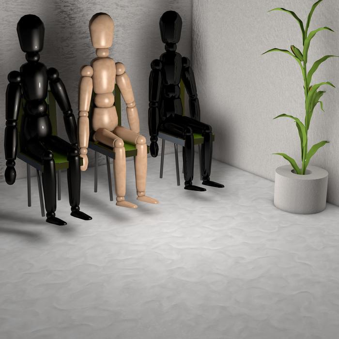 males wooden figures at waiting room
