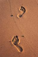 man feet on the sand