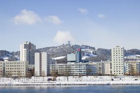 city panorama on the bank of a snowy river