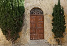 vintage wooden door of a stone building in Malta