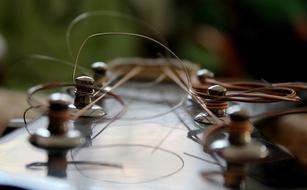 strings of Guitar on tuners close up