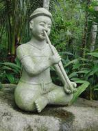 Buddhist sculpture with a pipe