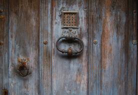 old wooden door with vintage metal handle