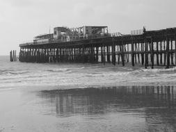 monochrome photo of pier on shore