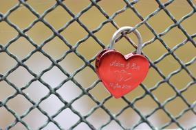 a fence with a beautiful red heart