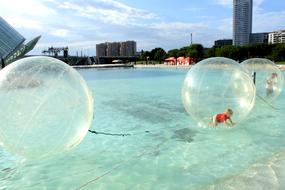 Child in the balloon, on the turquoise water in Valencia, Spain