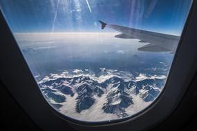 Plane at Sky over Mountains