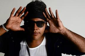 Portrait of Cazuza singer with open hands, in sunglasses