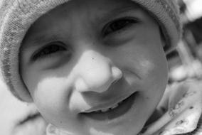 face of Child Boy in winter hat close up