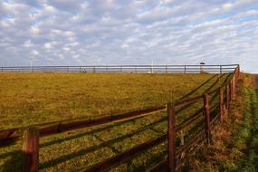 photo of the fence along the autumn pasture