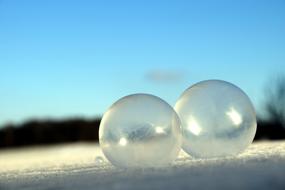 two soap bubbles in the snow