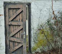 old open wooden door and white wall