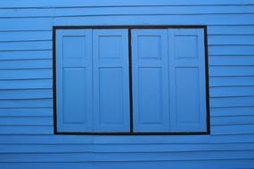 Beautiful, blue wooden shutters of the blue house