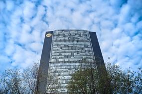 white clouds over a skyscraper, bottom view