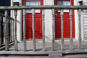 Red doors of the house, with the railing