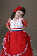 Smiling girl in red, white and blue clothing in Paraguay