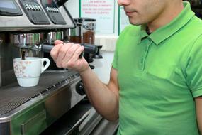 man makes coffee