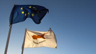 flags flying in the wind in the sunshine