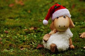 figurine of ceramic lamb in santa claus hat
