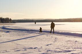 Family of Child Father walking on snowy countryside