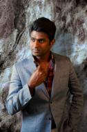 indian man fashion model on stone wall background