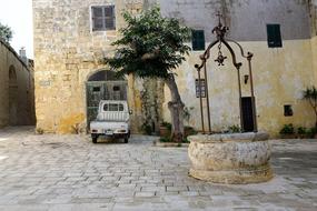 aged stone well in courtyard of House, Malta, Mdina