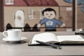 notebook with a mug on the table