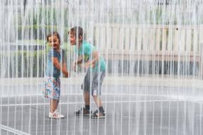 children playing in the city fountain