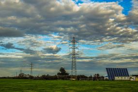 Beautiful landscape with the electricity pylon and solar panel, among the colorful plants in Avgorou, Cyprus, Greece