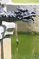 stone Figure Dragon Fountain on a blurred background