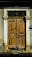 Door Wooden Old on the facade of a building on a sunny day