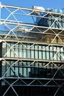 view of the building with a glass facade through the mesh