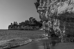 rocks with a lake in black and white tons