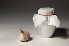 white jar and garlic