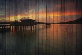 picture of a fishing house on stilts on a wooden wall