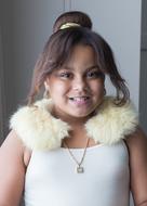 portrait of happy Bi-Racial child Girl in white fur neckband