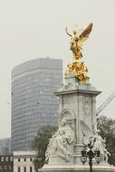 London fog over golden sculpture