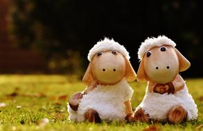 two ceramic sheep on the lawn