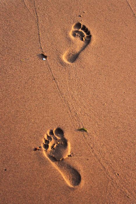 man feet on the sand