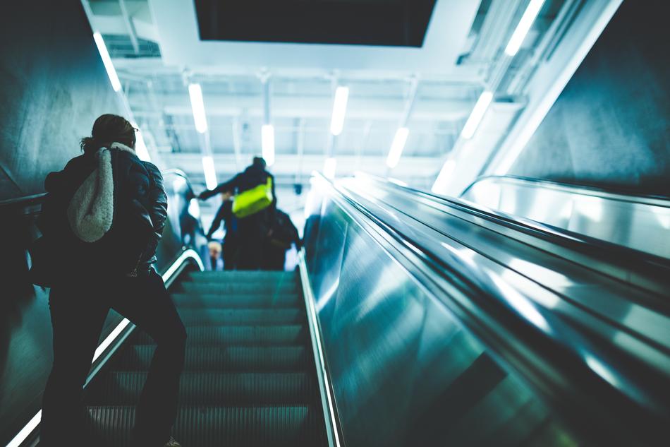 people on the escalator in the subway