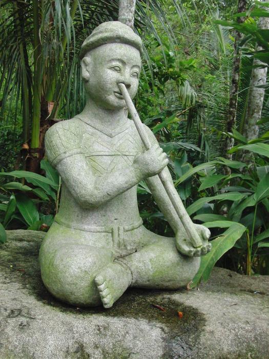 Buddhist sculpture with a pipe