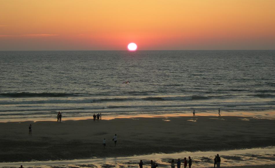the sun burning over the sea