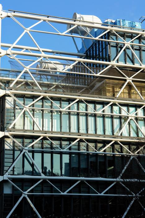 view of the building with a glass facade through the mesh