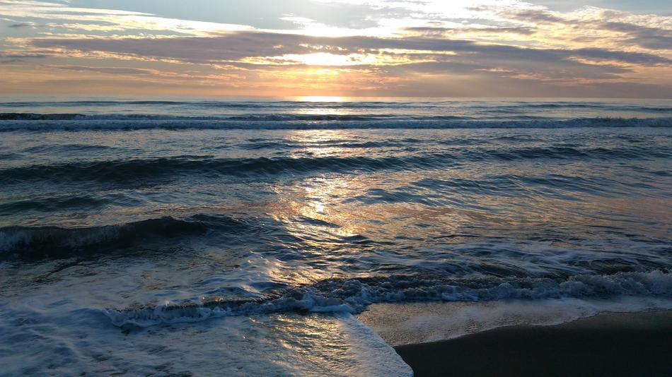 Sea waves against the background of the dawn