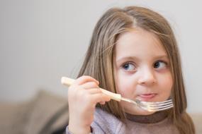 little girl with a fork