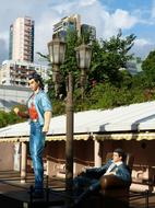 Colorful figures near the lantern, in the park of Kowloon, Hong Kong, among the colorful buildings