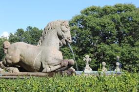 horse stone sculpture, aged water fountain in park, Italy, Lazio, Caprarola